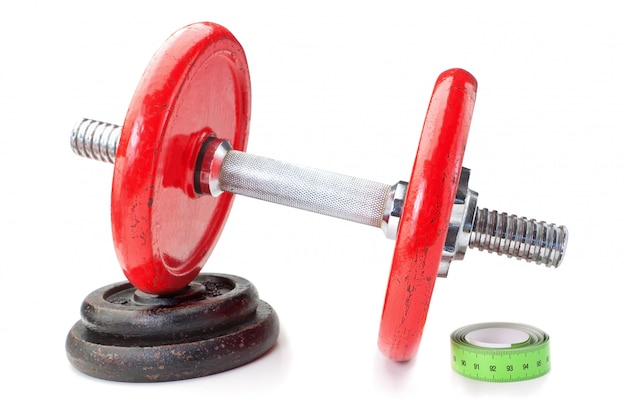 Dumbbell on disk and tape measure meter. For fitness. Slimming.