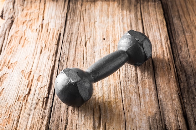 dumbbell on wooden table background