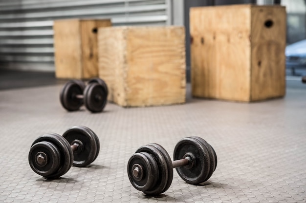 Photo dumbbells on the floor at the crossfit gym