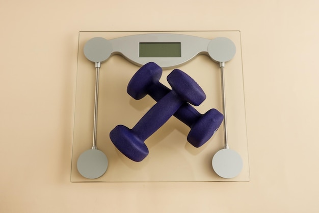 Dumbbells on floor scales weight loss workout at home