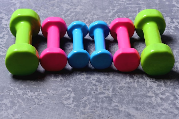 Photo dumbbells made of pink green and cyan plastic