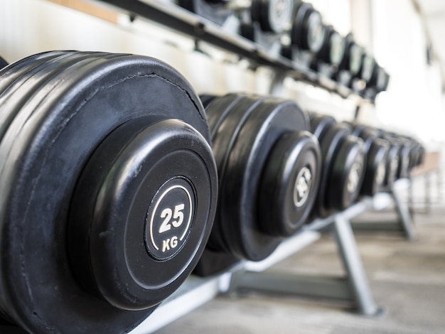 Dumbbells set left on the racks in the gym.