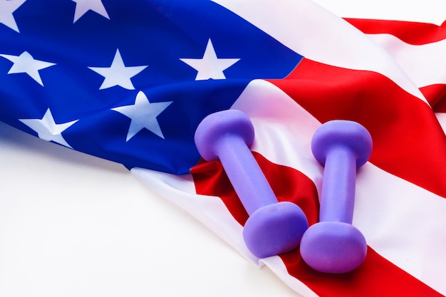 Photo dumbbells over usa flag. healthy nation.