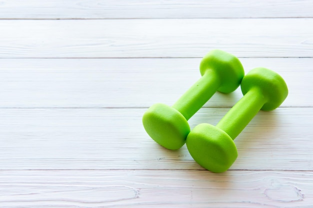 Dumbbells on a wooden background The concept of a healthy lifestyle