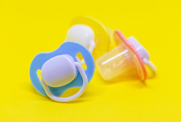 Dummy pacifiers for newborns in different colors selective focus