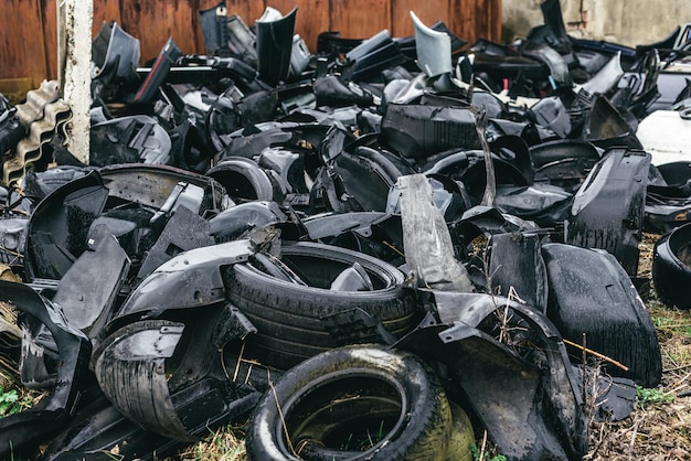 A dump of broken rusted cars their parts and tires