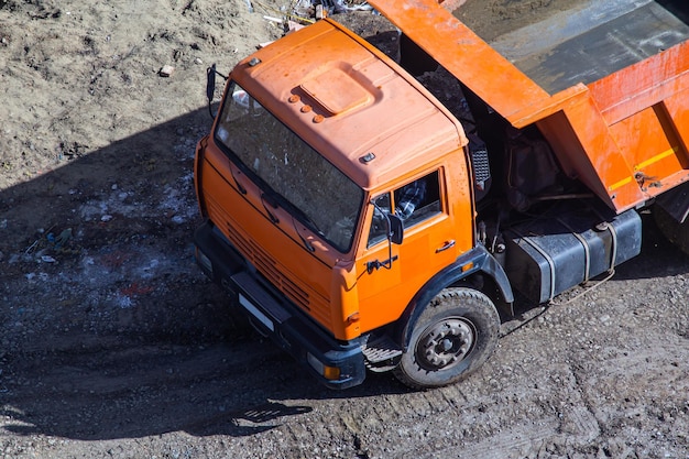 Dump truck unloading soil at construction site