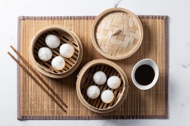 Dumplings in bamboo steamer on marble background