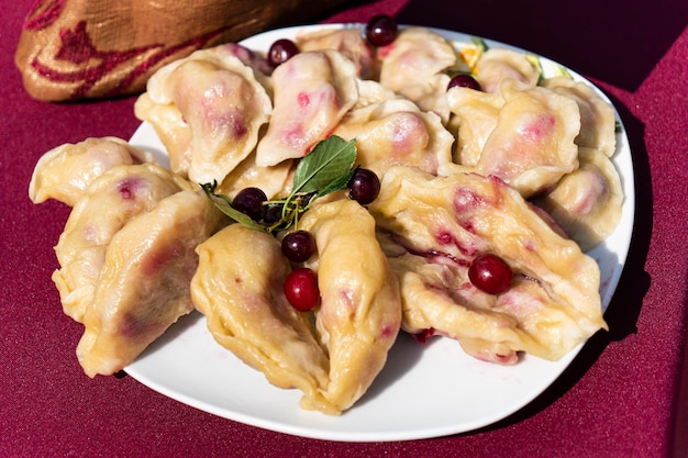 Dumplings filled with cherries berries Pierogi varenyky vareniki pyrohy dumplings with filling