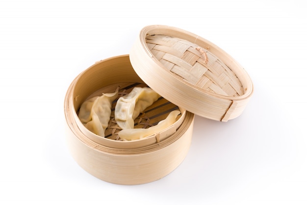 Dumplings or gyoza served in traditional steamer isolated