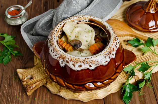 Dumplings in a pot on a wooden table