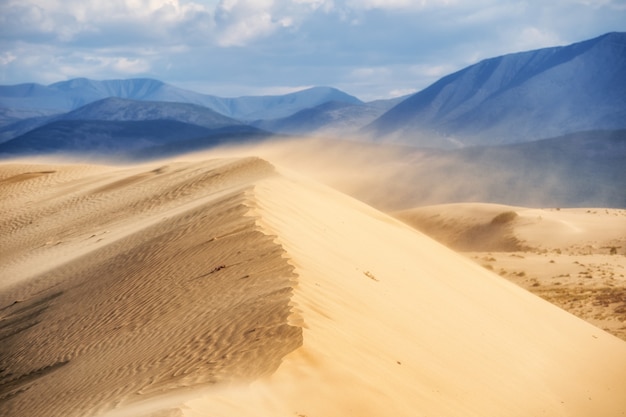 The dune of the northernmost desert in the world against the backdrop of mountain ranges