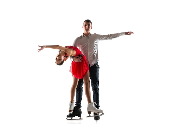 Duo figure skating isolated on white wall with copyspace. Two sportsmen practicing and training in action and motion. Full of grace and weightless. Concept of movement, sport, beauty.