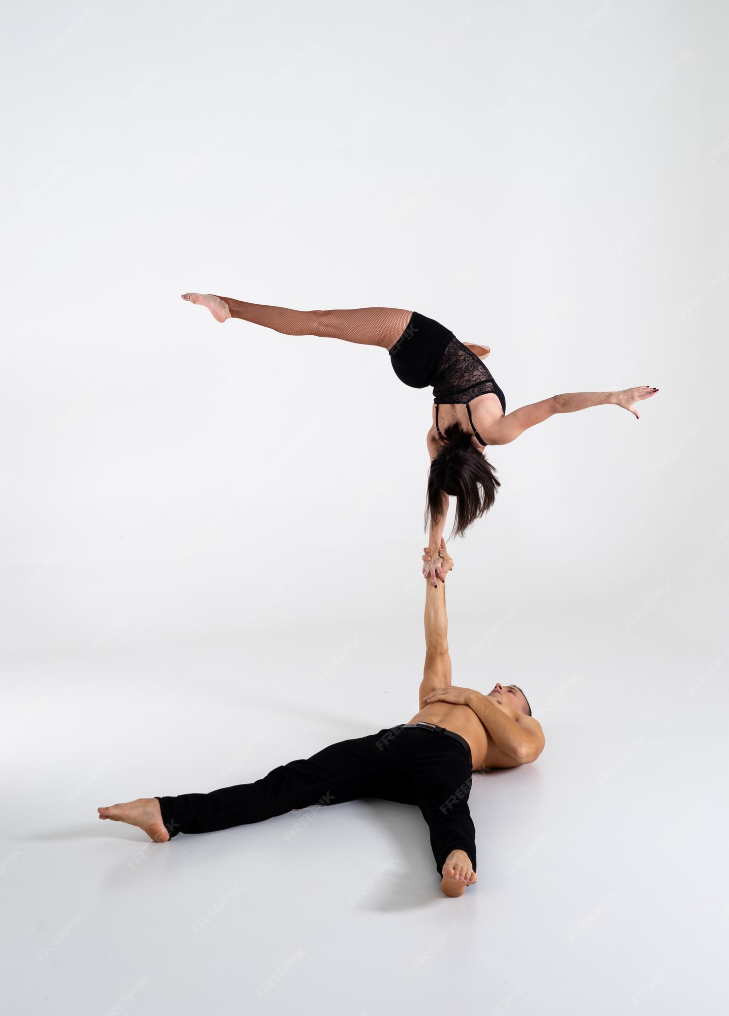 Duo Of Male And Female Acrobats Showing Hand To Hand Trick, Isolated On  White Stock Photo, Picture and Royalty Free Image. Image 141734000.