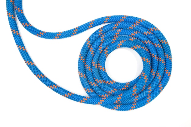 Durable colored rope for climbing equipment on a white background coil of braided cable item for tourism and travel