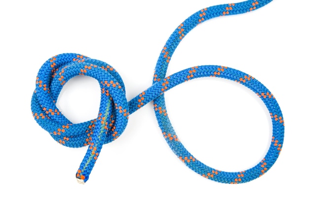 Durable colored rope for climbing equipment on a white background coil of braided cable item for tourism and travel