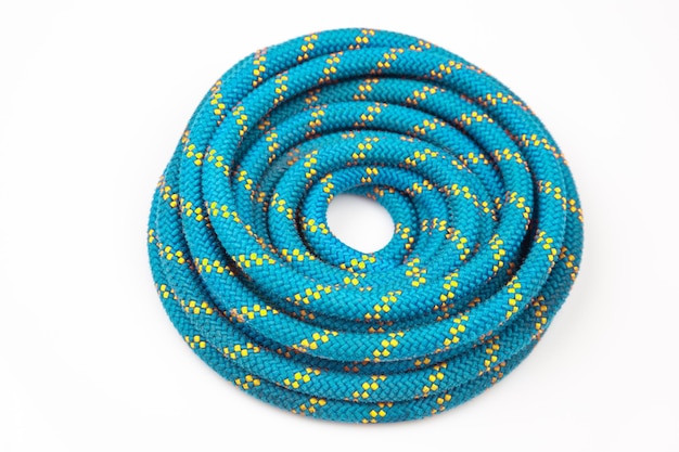 Durable colored rope for climbing equipment on a white background knot of braided cable item for tourism and travel