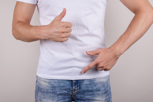 Photo duration no problem therapy treatment passion urology concept. cropped close up photo of happy glad guy showing demonstrating groin zipper pants trousers jeans make give like isolated grey wall