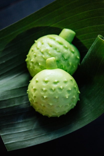 Durian buns in shape of durian served on banana leaf.