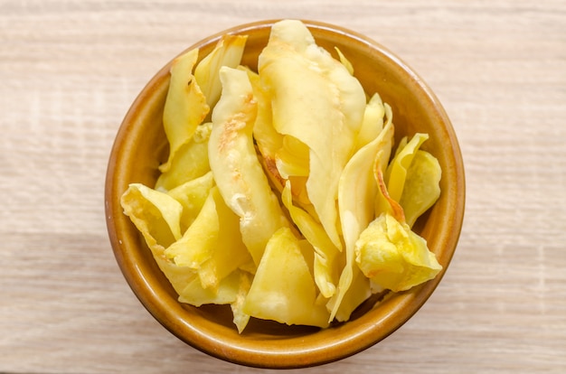 Durian chips fried snack fruit in brown blow on wooden background