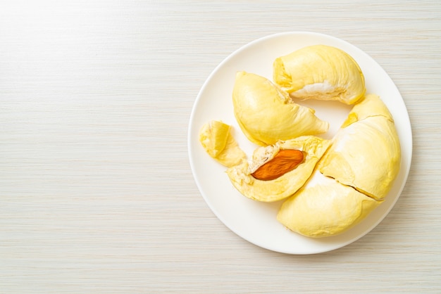 Durian stagionato e fresco, buccia di durian su piatto bianco