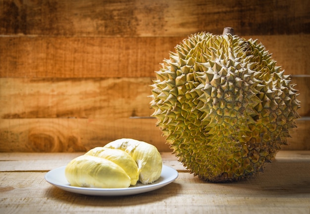 Durian riped on plate and durian fruit on wooden background on summer