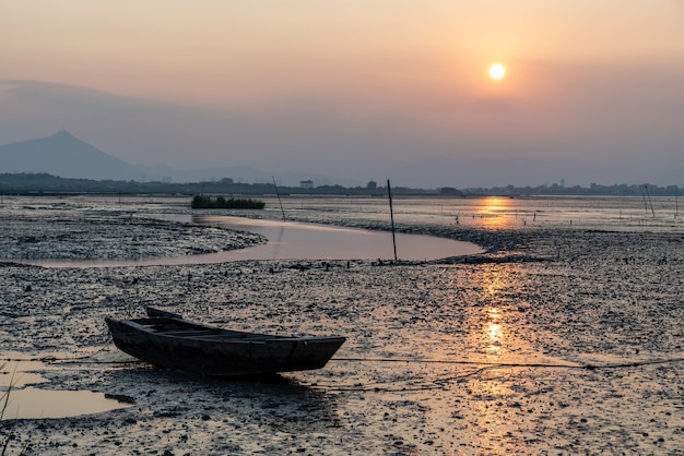 At dusk, abandoned fishing boats docked in the shoal