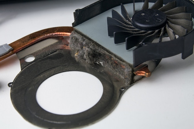 Dust on the cooler of the laptop cooling system