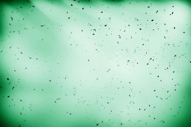 Photo dust particles on green paper texture background hd