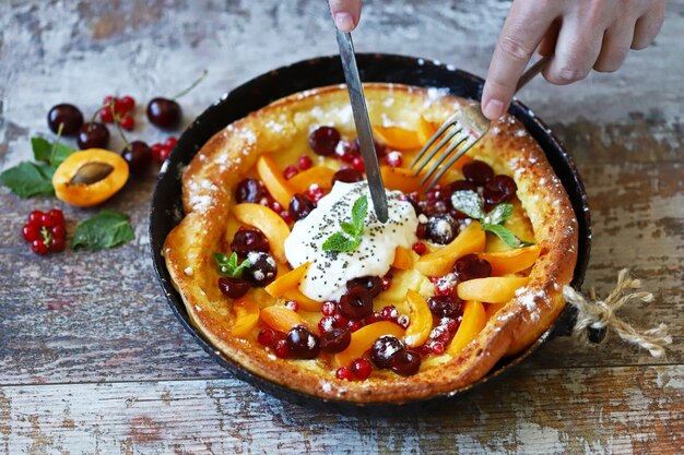 Dutch baby pancake with berries and yogurt