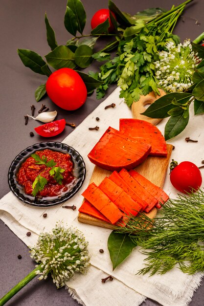 Dutch gouda red cheese on trendy black stone concrete background