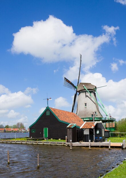 Dutch windmill over Zaan river waters, Holland