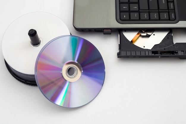 DVD or CD disc with laptop on white background.