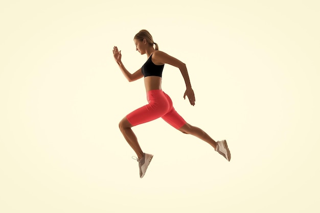 Dynamic movement Woman runner isolated on white Jogger running Sporty runner in fashionable sportswear Fitness and sport motivation Strong and fit Athletic woman sprinter or runner Best runner