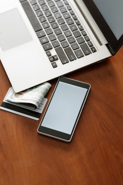 E-commerce advertisement. Laptop computer and phone with white screen. Modern technology