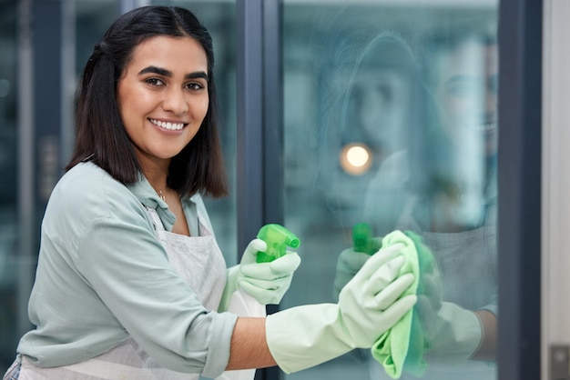 Each day is an opportunity to clean Shot of a young woman cleaning her windows