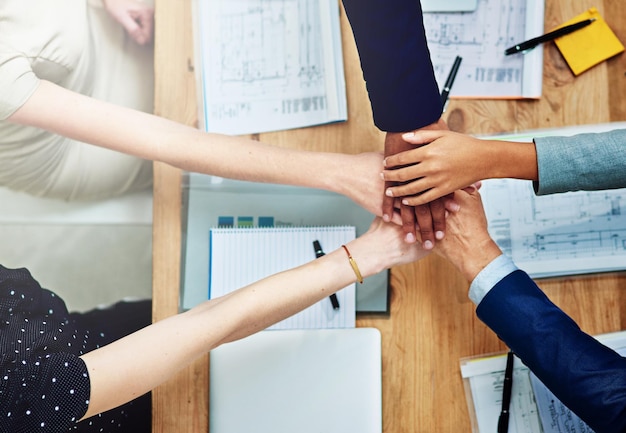 Each individual an integral part of the whole Cropped shot of a group of unidentifiable businesspeople putting their hands on top of each other during a meeting