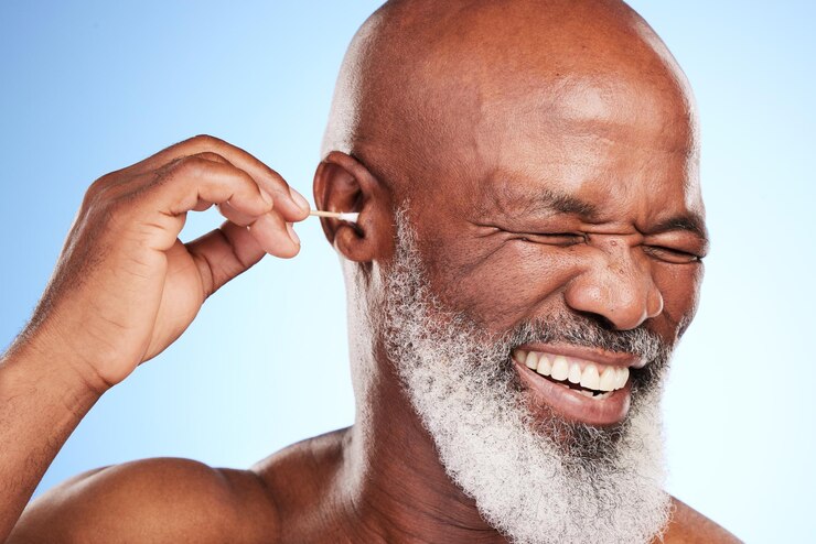 Photo ear cotton swab and elderly man in studio for wax removal hygiene or self care on blue background body cleaning and senior model with product for grooming healthy hearing or morning routine