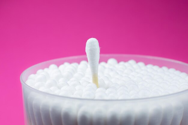 Photo ear cotton swabs on the pink background hygienic ears sticks