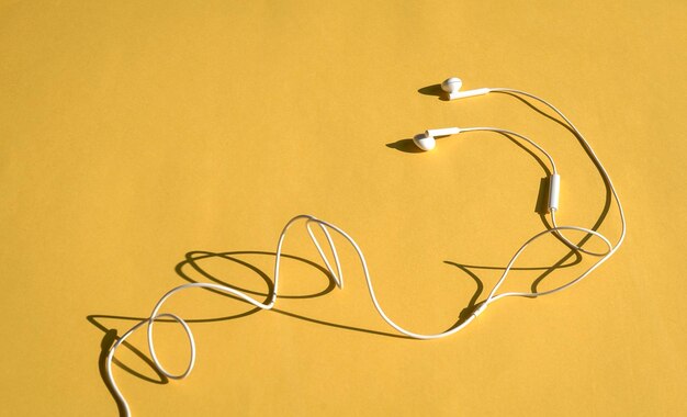 Ear phones on yellow background