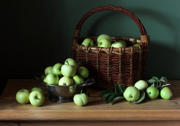 Early green apples in a basket on the table. still life with apples "white filling". fresh fruit.