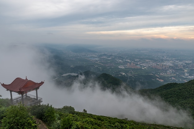 Early in the morning, peaks in the fog, fields and villages.