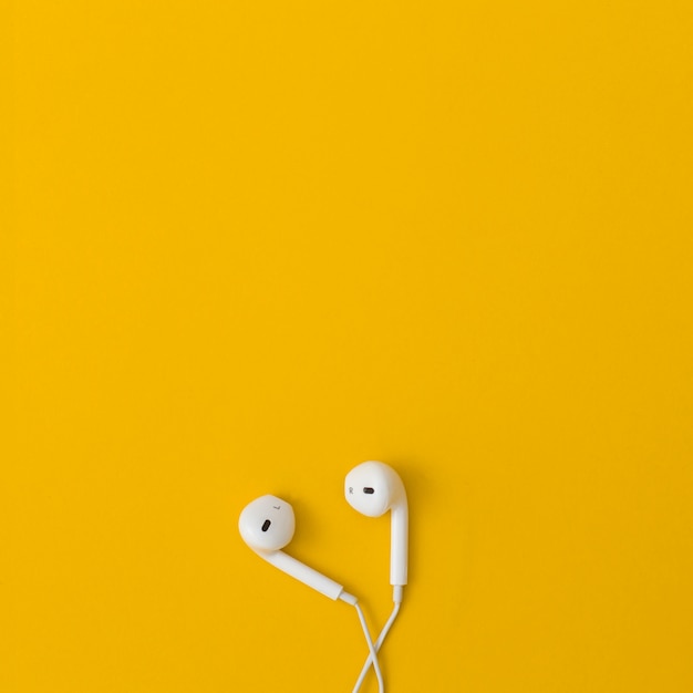 Photo earphone on yellow background.