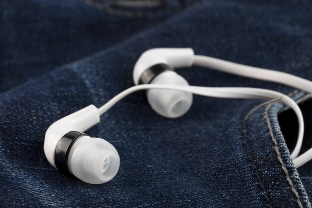 earphones in the pocket old jeans