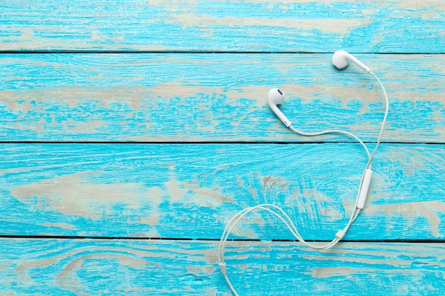 Earphones on wooden table