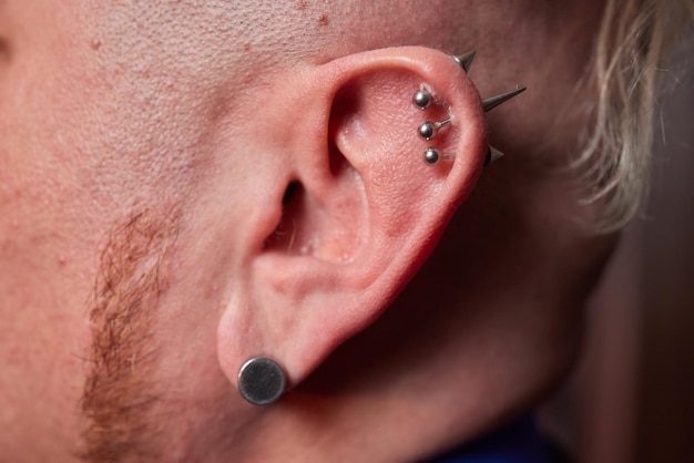 Earring in the male ear Piercing Part of the body Young man