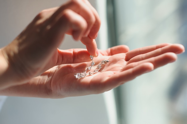 Earrings in a female palm