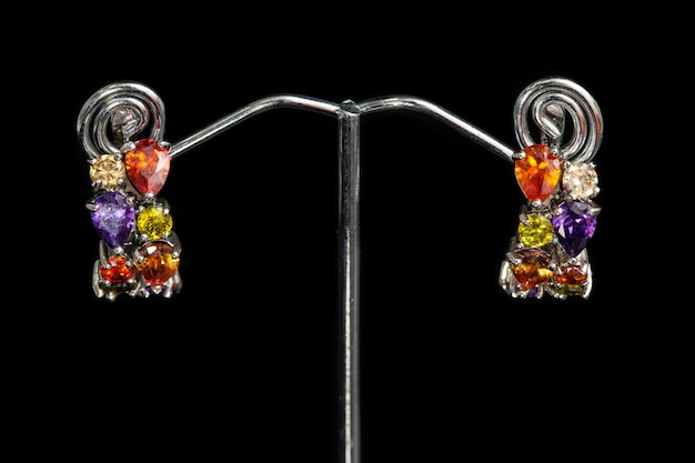 Earrings with colorful stones on black