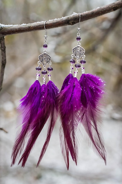 Earrings with feathers on the branch