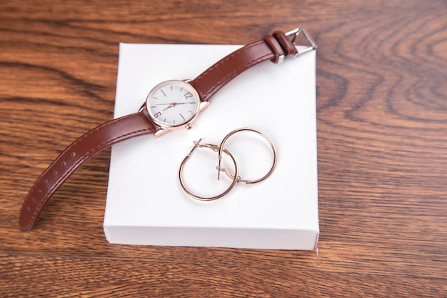 Earrings with watch on box